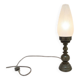 Old bronze or brass table lamp from the early 20th century with white streaked flame glass globe