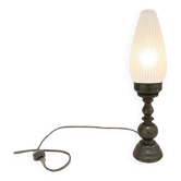Old bronze or brass table lamp from the early 20th century with white streaked flame glass globe