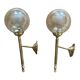 Pair of antique wall sconces torch style brass with glass globes in gold.