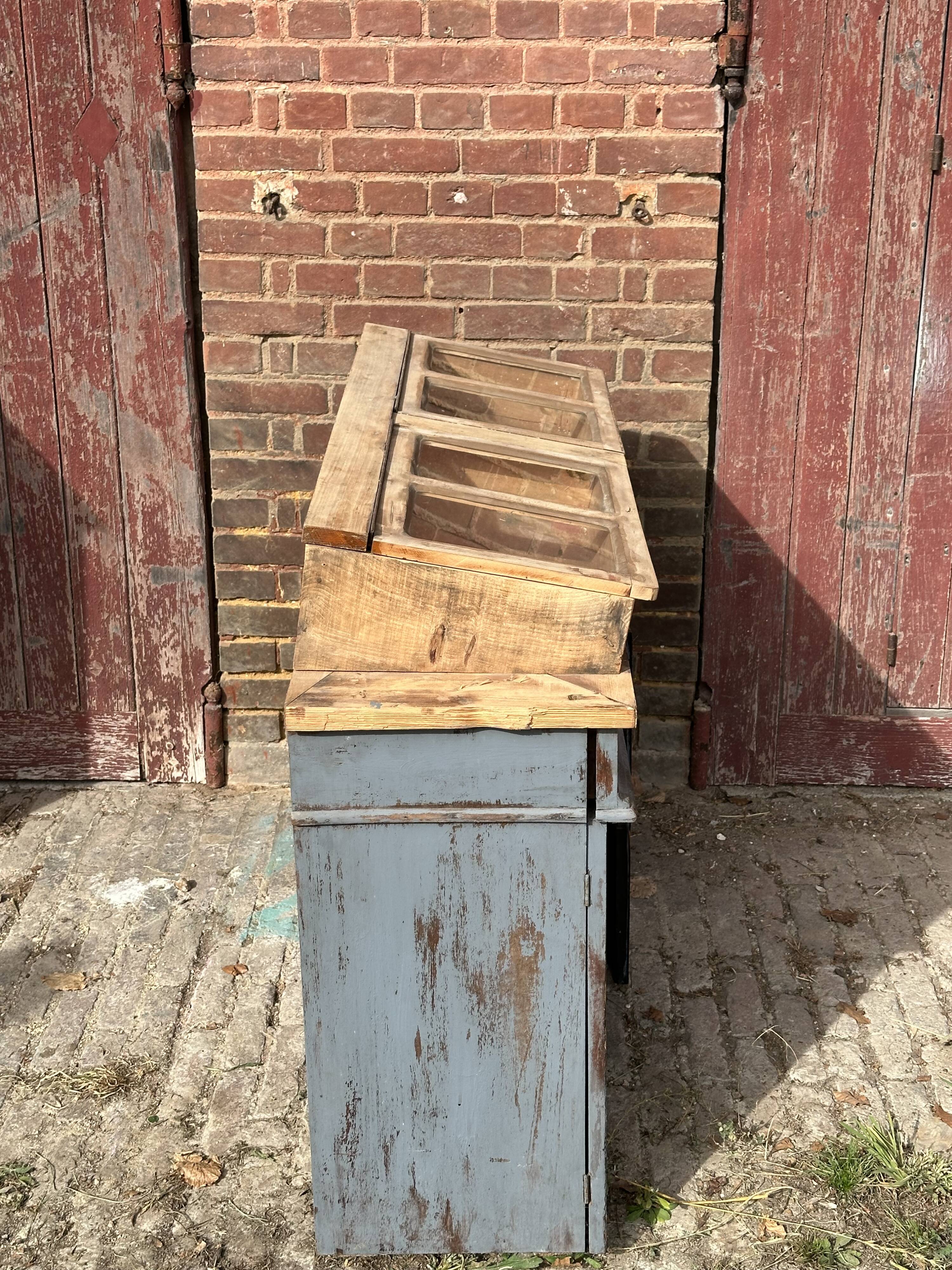 Showcase for boutique furniture, inclined boxes for presentation of collections on low sideboard