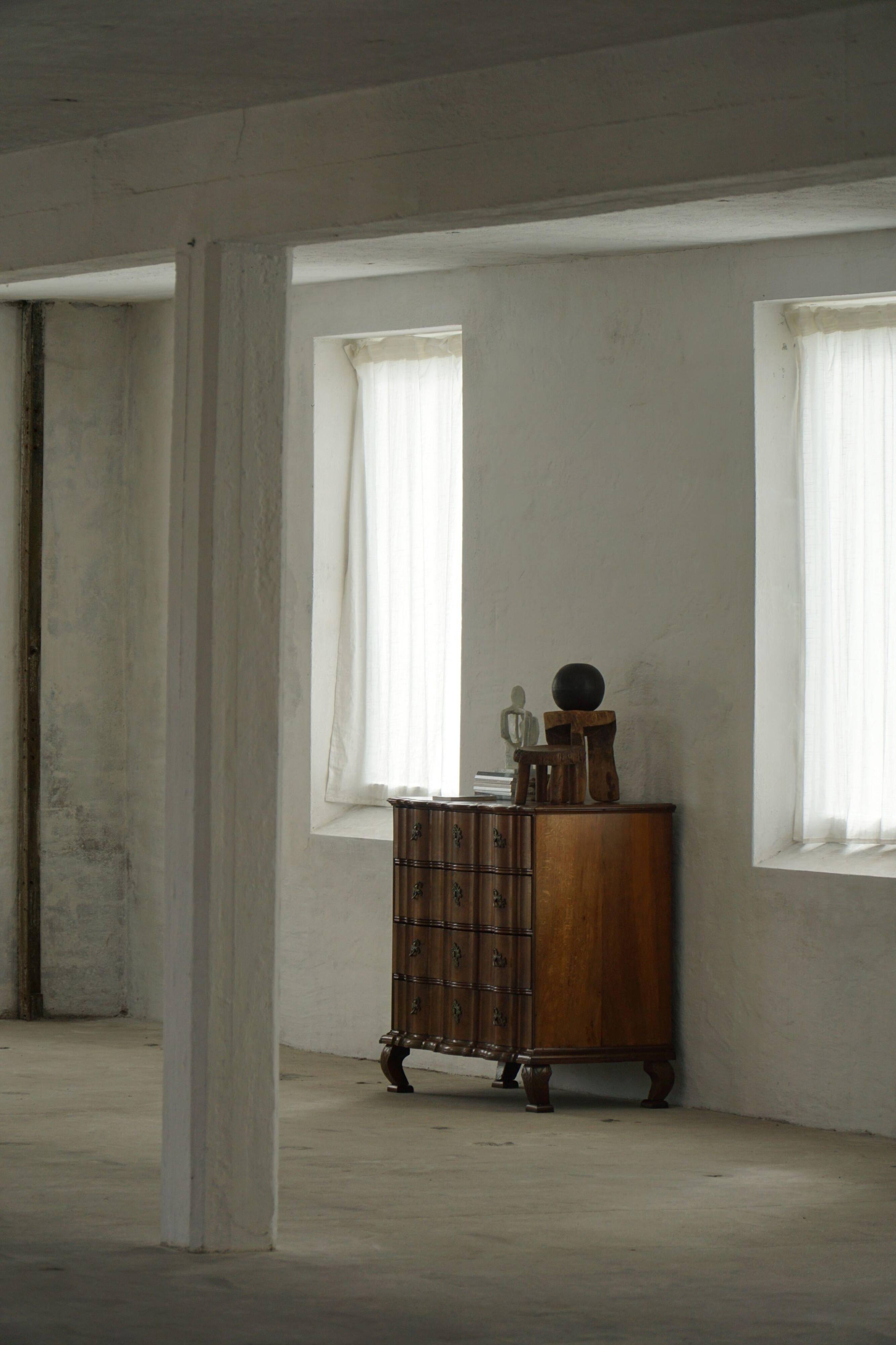 Antique baroque oak commode from the late 18th century with cabriole legs.