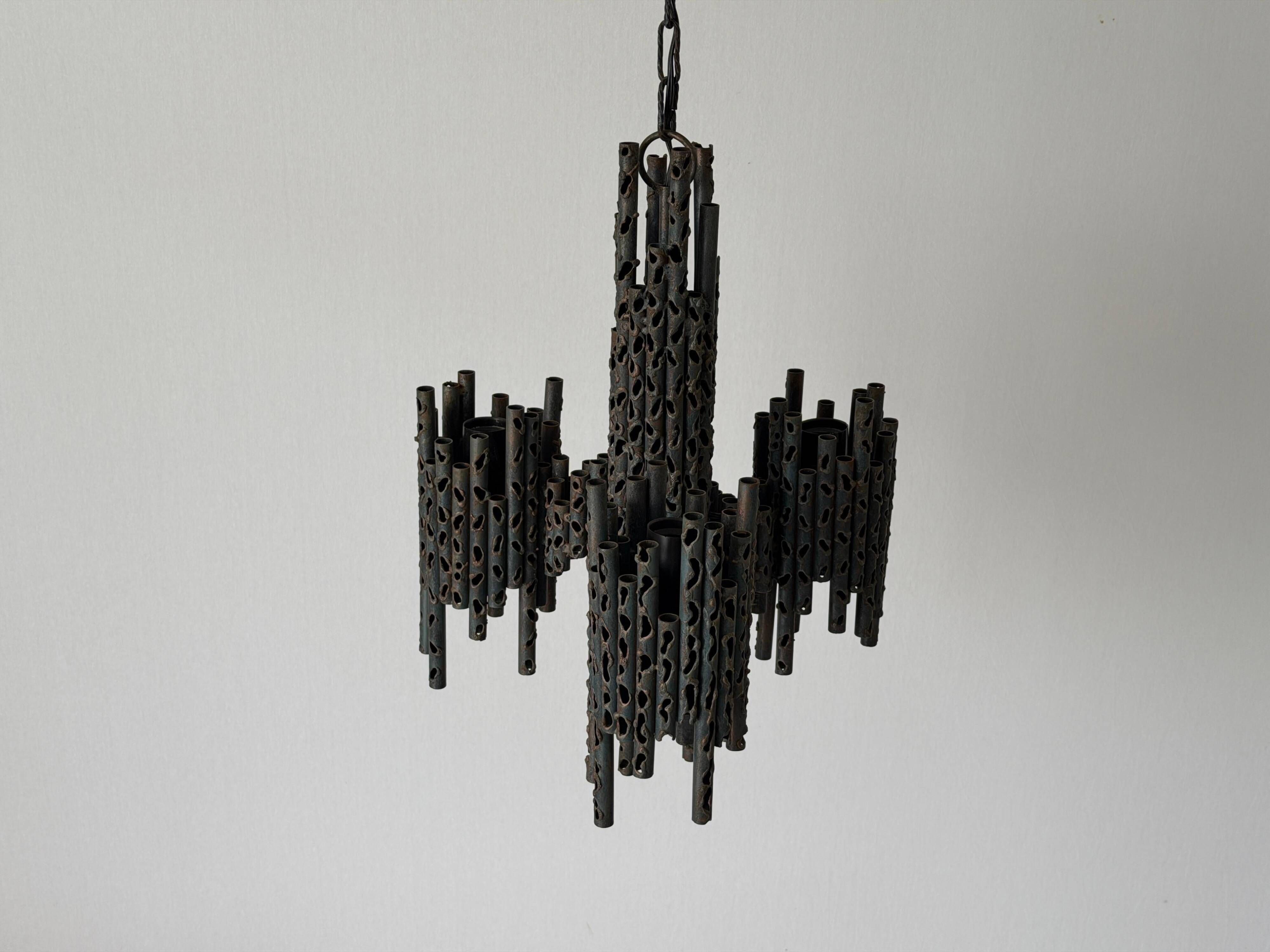 Three-armed suspended lamp in wrought iron, brutalist design, 1960s, Italy.