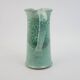 Large green ceramic pitcher with leopard enamel