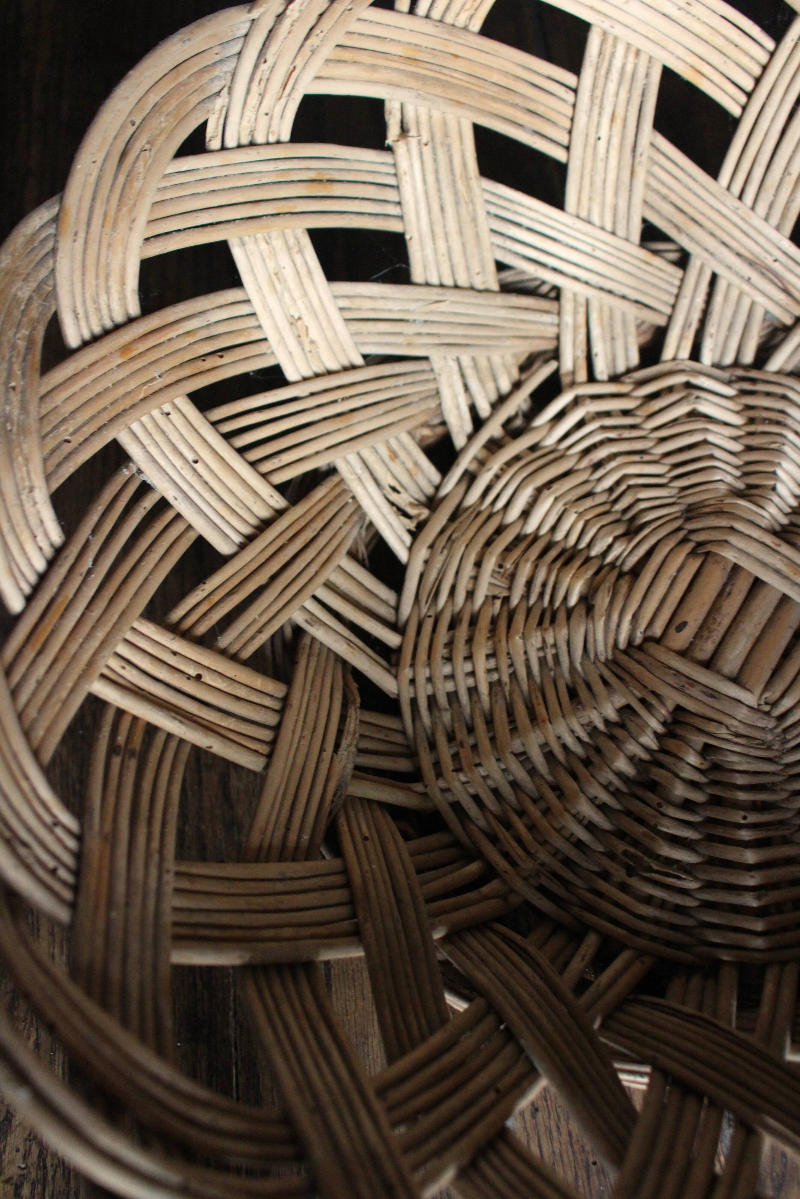 Large vintage twisted wicker basket on a stand