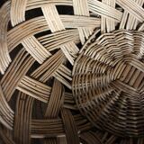 Large vintage twisted wicker basket on a stand