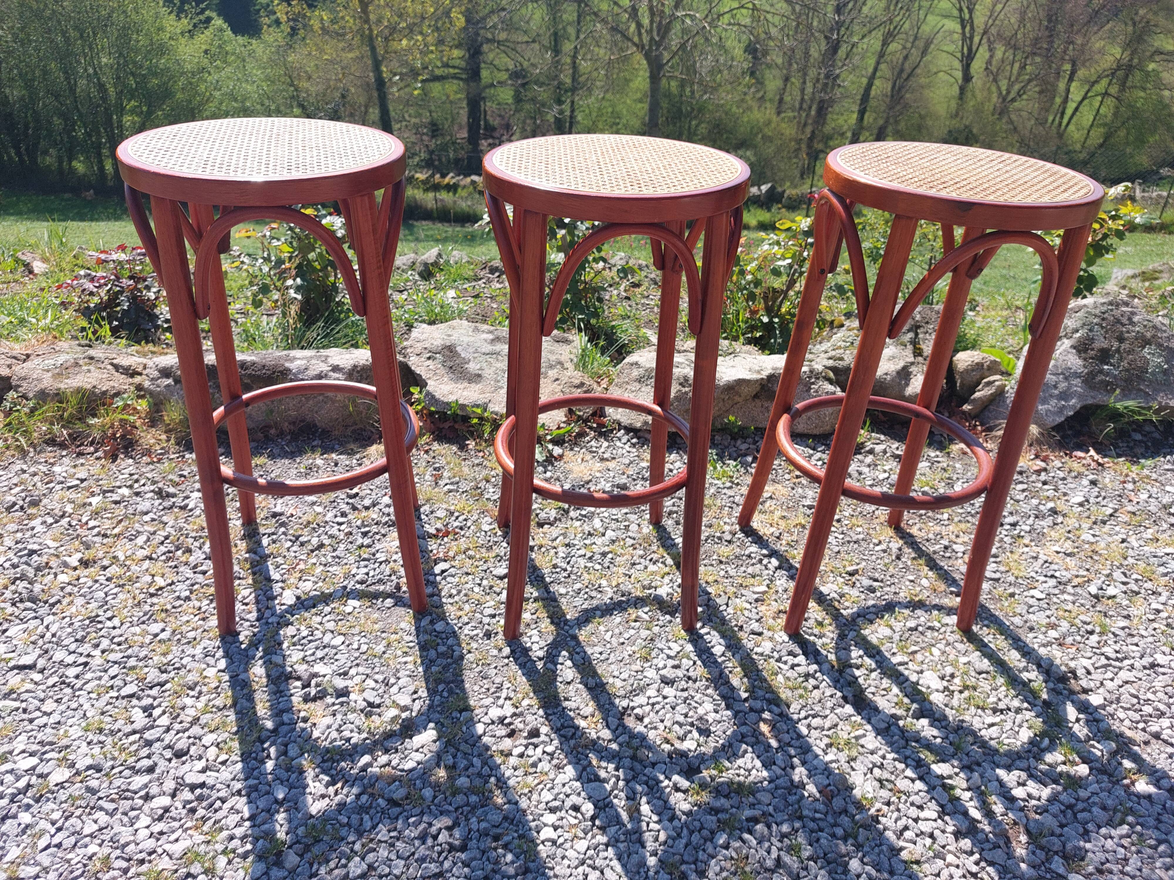 3 wooden and cane bar stools