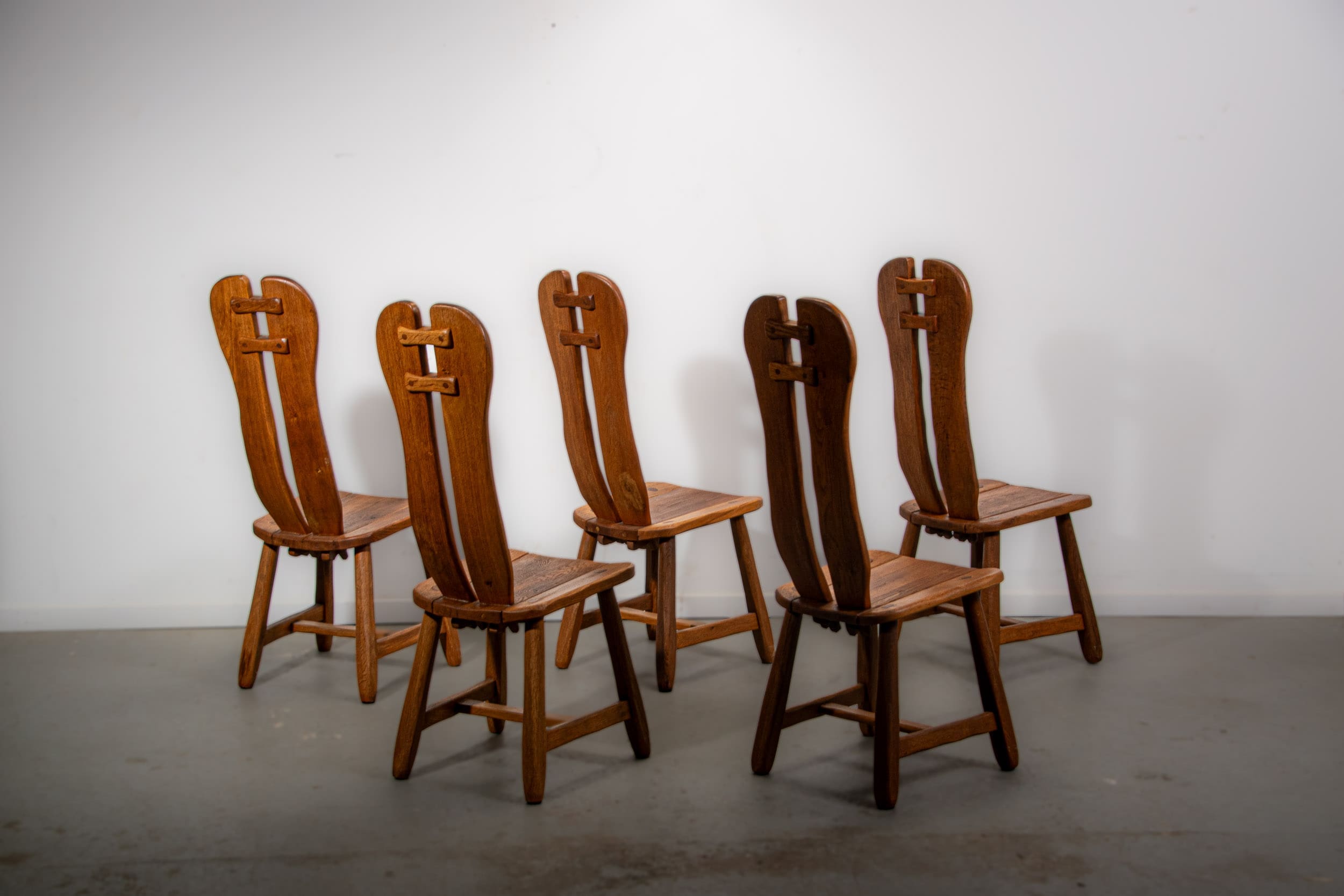 De Puydt brutalist dining chairs in solid oak. Circa 1970.