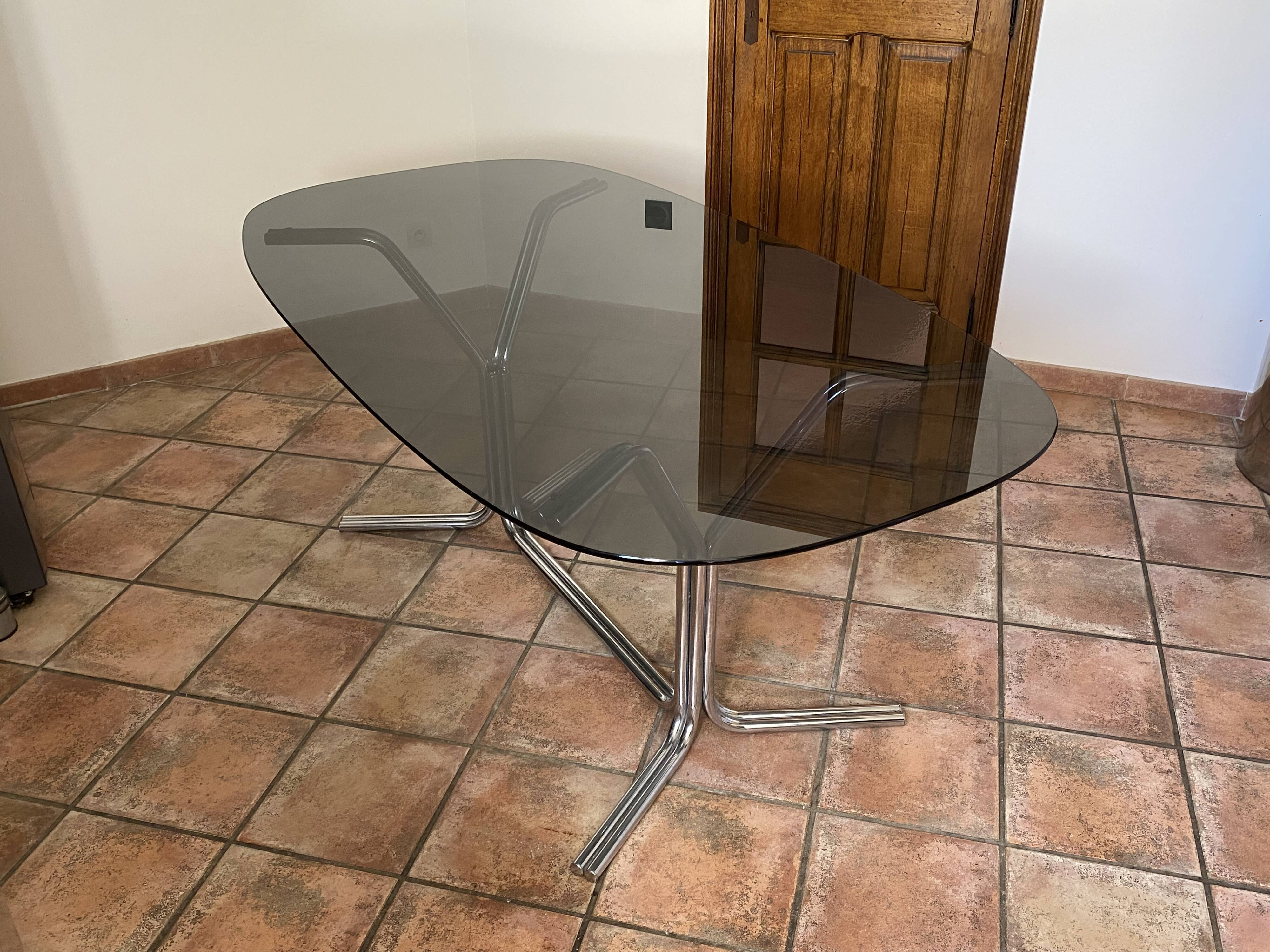 Oval table. 1970. Steel and smoked glass. 180x100