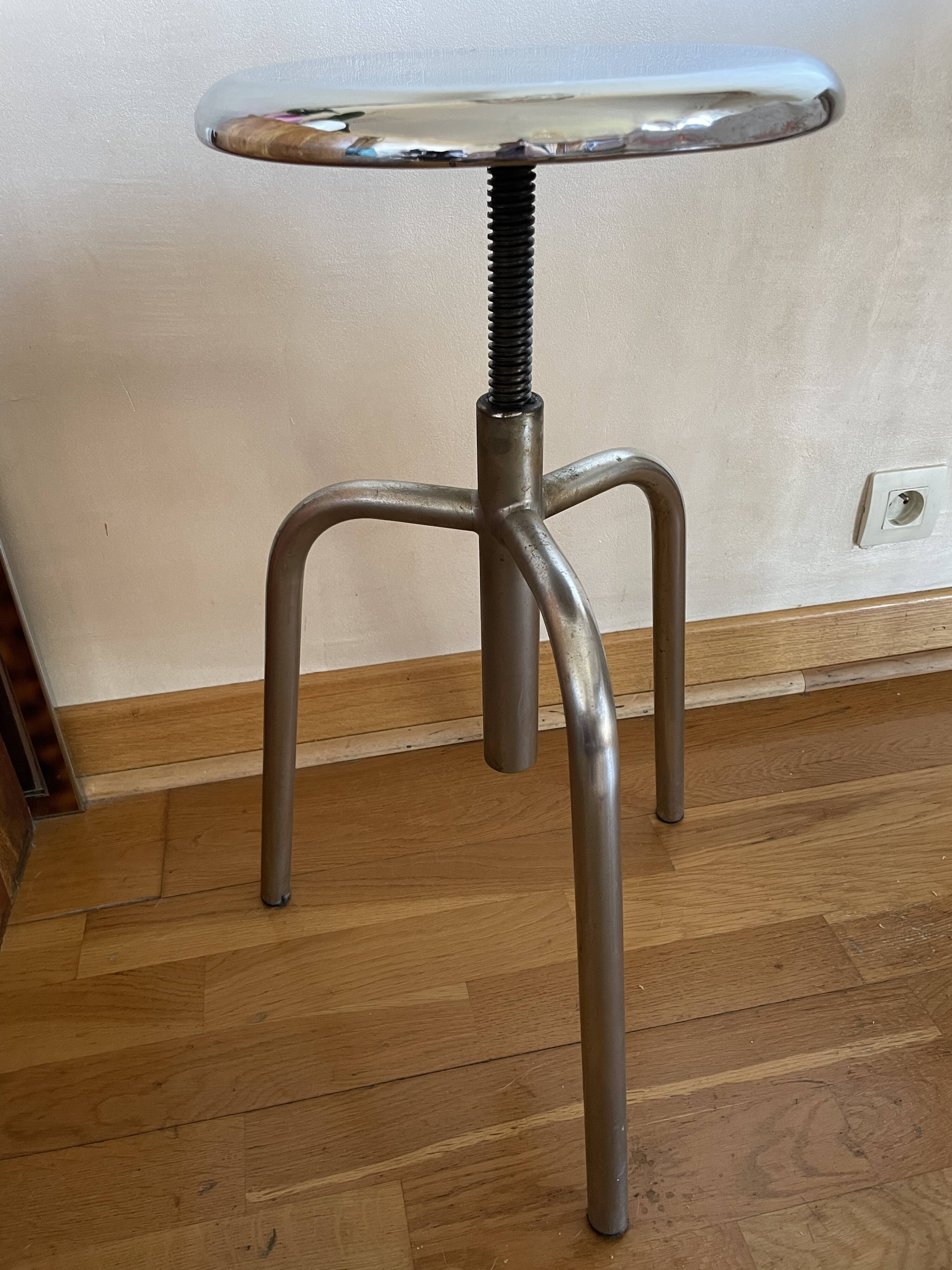 Chrome screw stool of hairdresser workshop