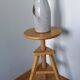 Tripod stool with a screw.