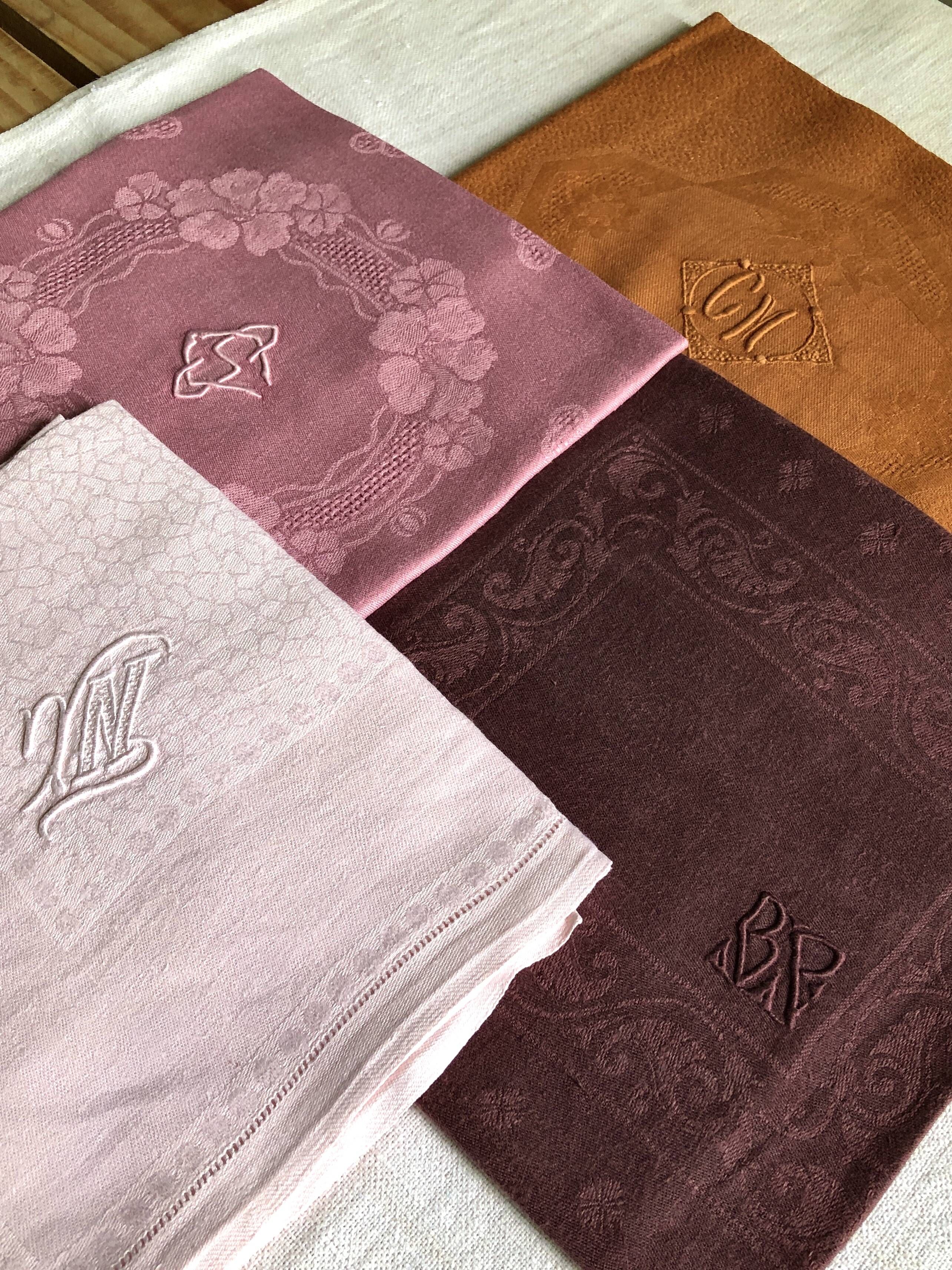 Set of four old damask towels tinted in multiple colors