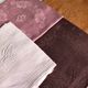Set of four old damask towels tinted in multiple colors