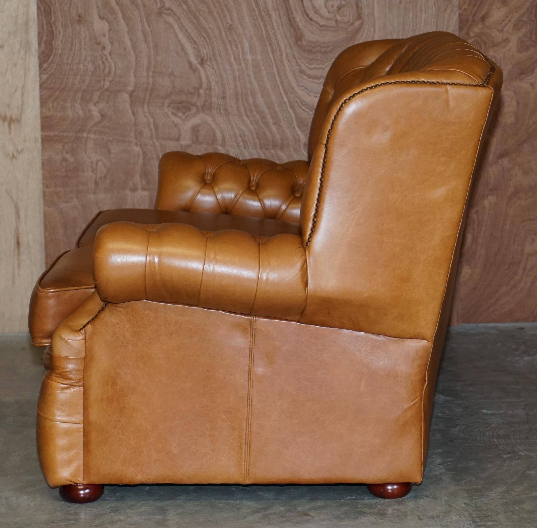 Small Chesterfield leather sofa with a high back.
