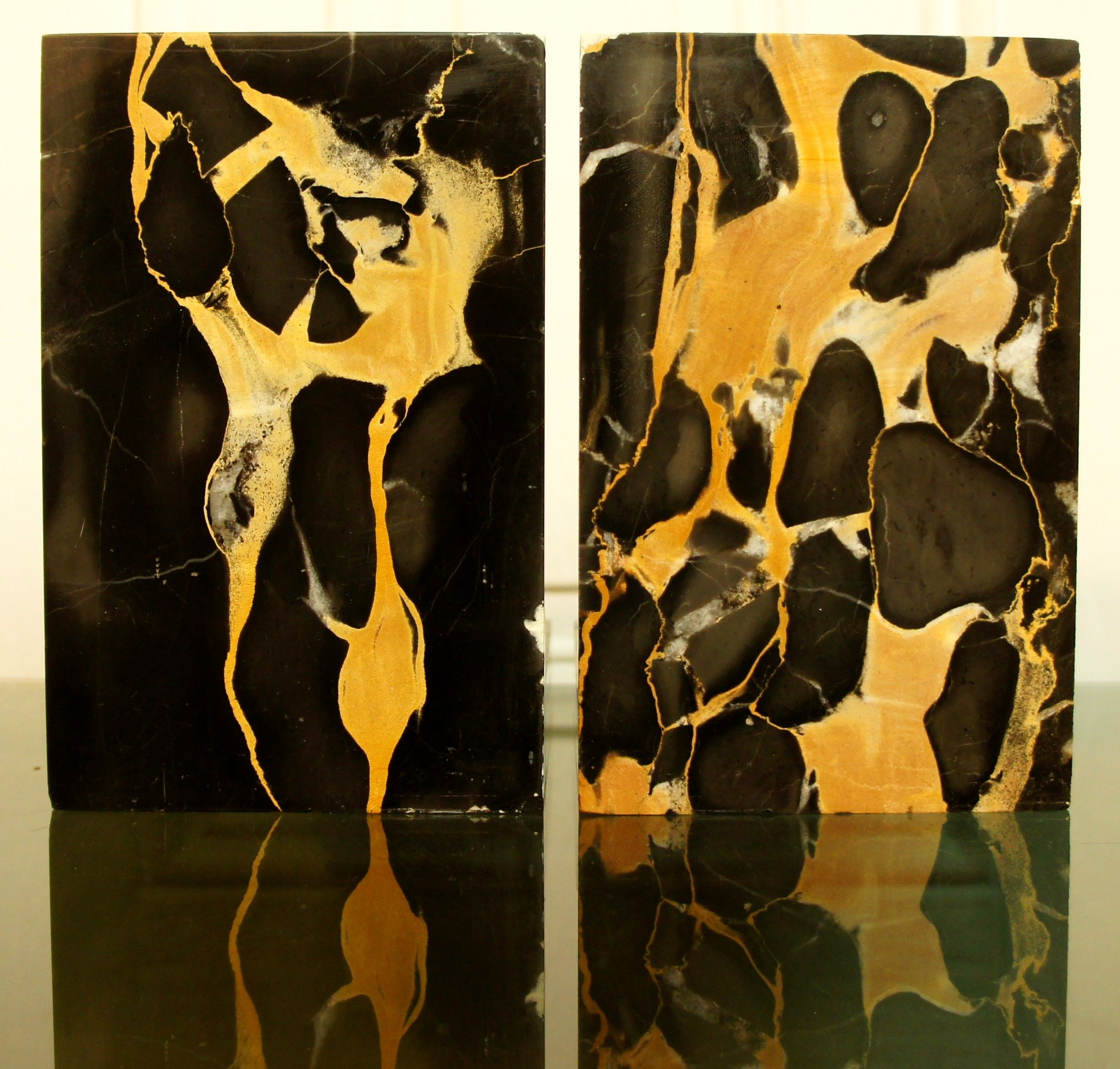 Pair of Portor marble bookends, black and golden yellow