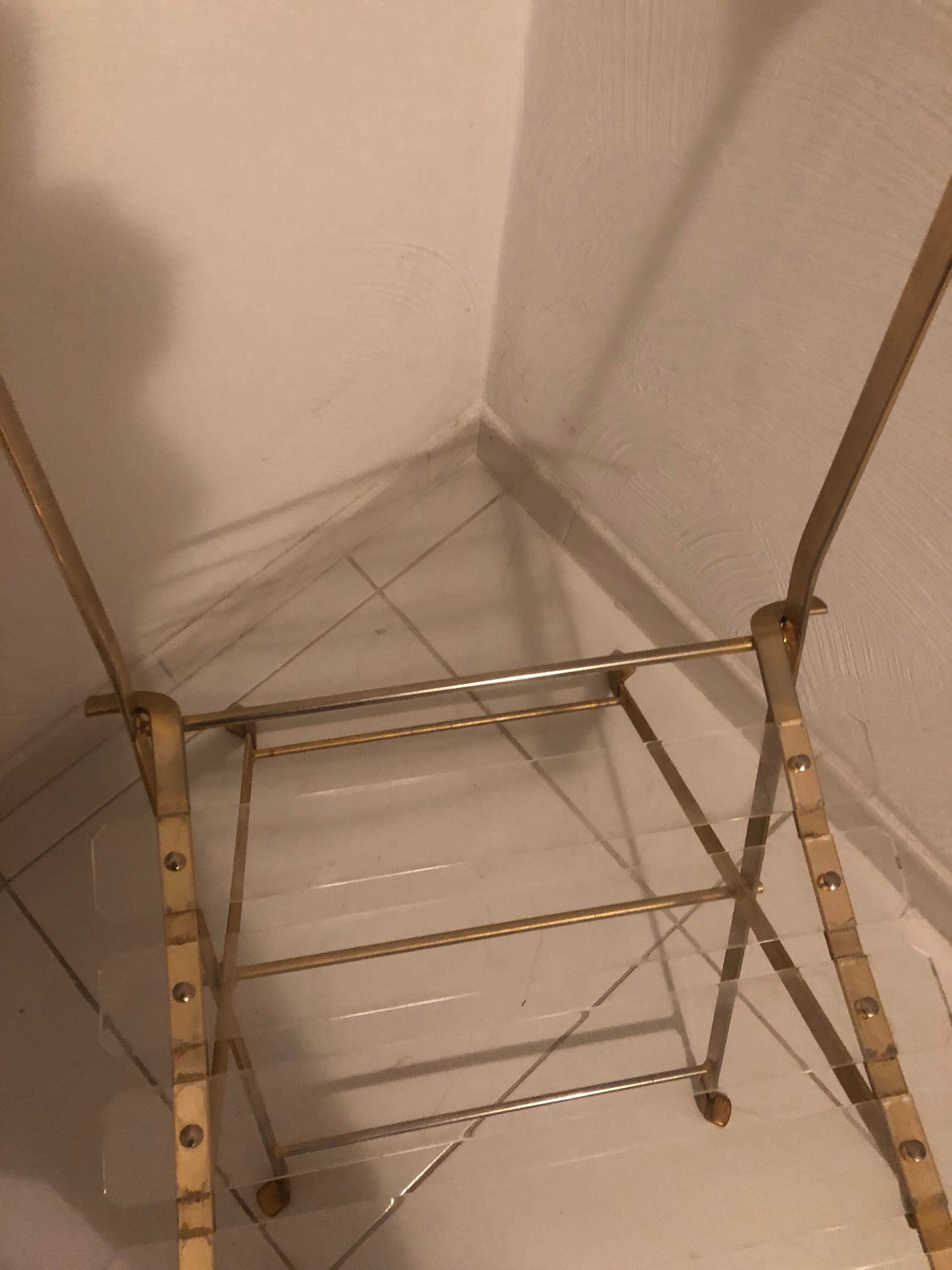 Folding chair in plexiglass and brass