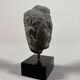 Sculpture of a Buddha head in grey schist from Gandhara, ancient Greece.