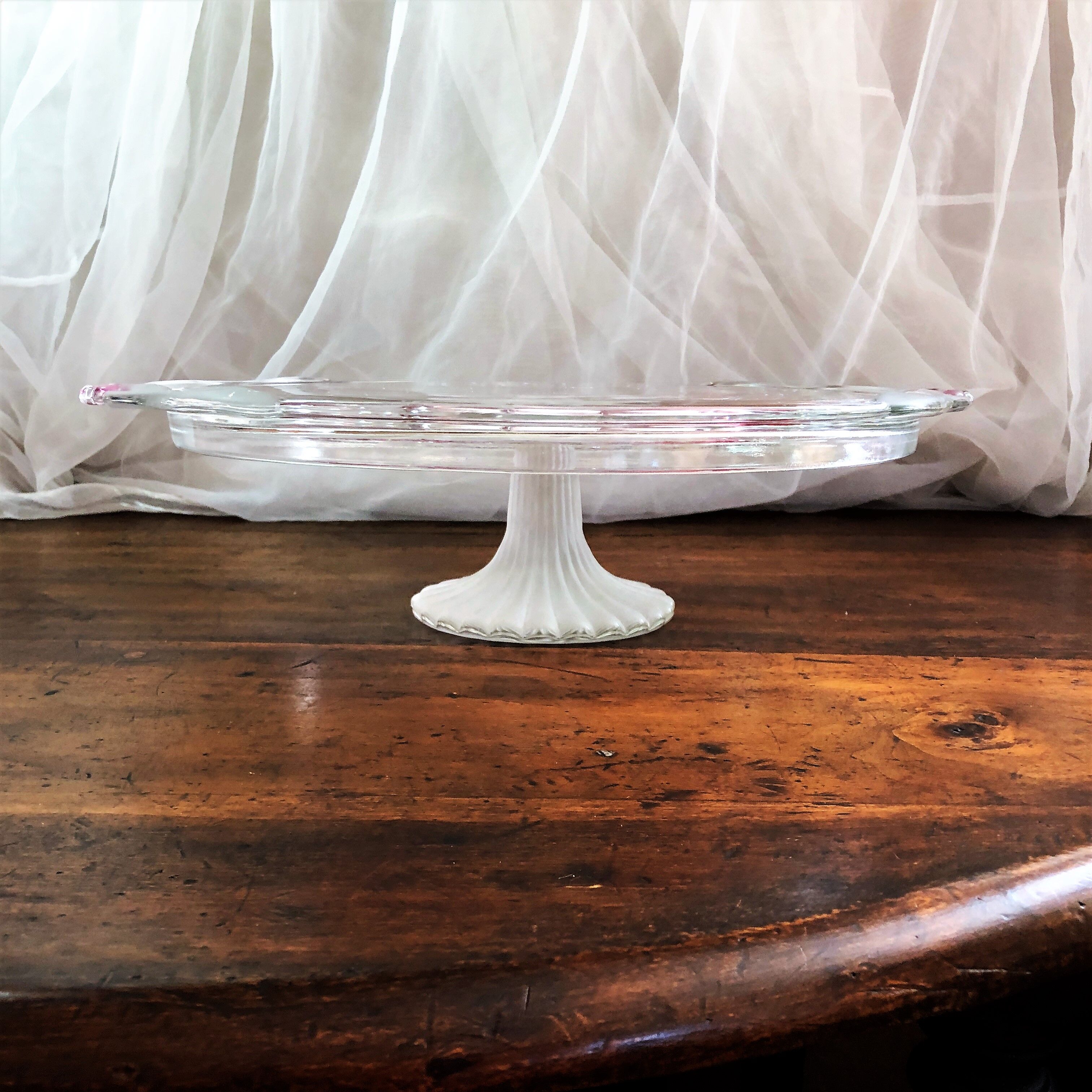 Large pie dish cakes on pedestal decorated with peacocks