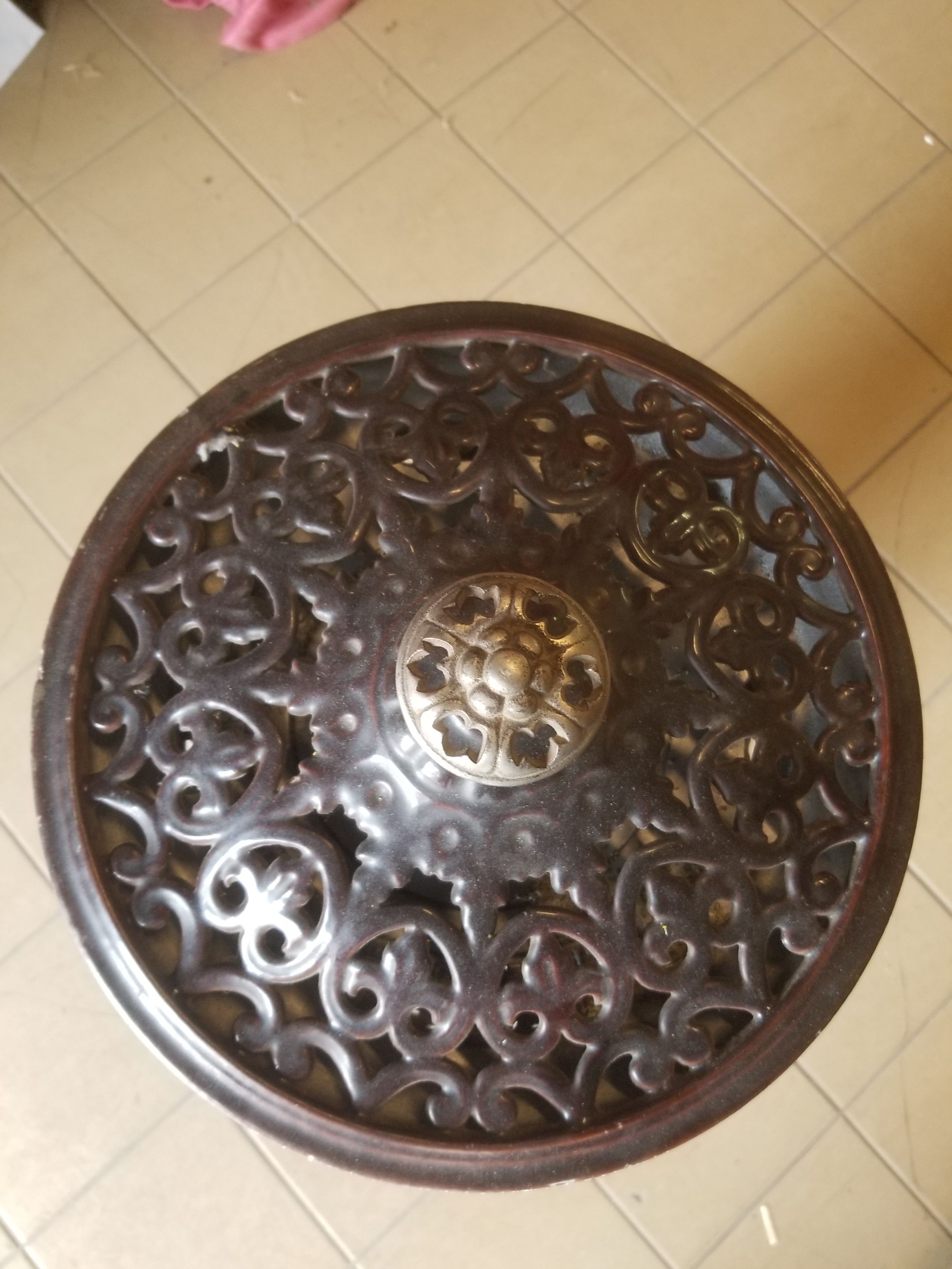 Old compact wood stove in enamelled cast iron with tripod feet with Lion's legs