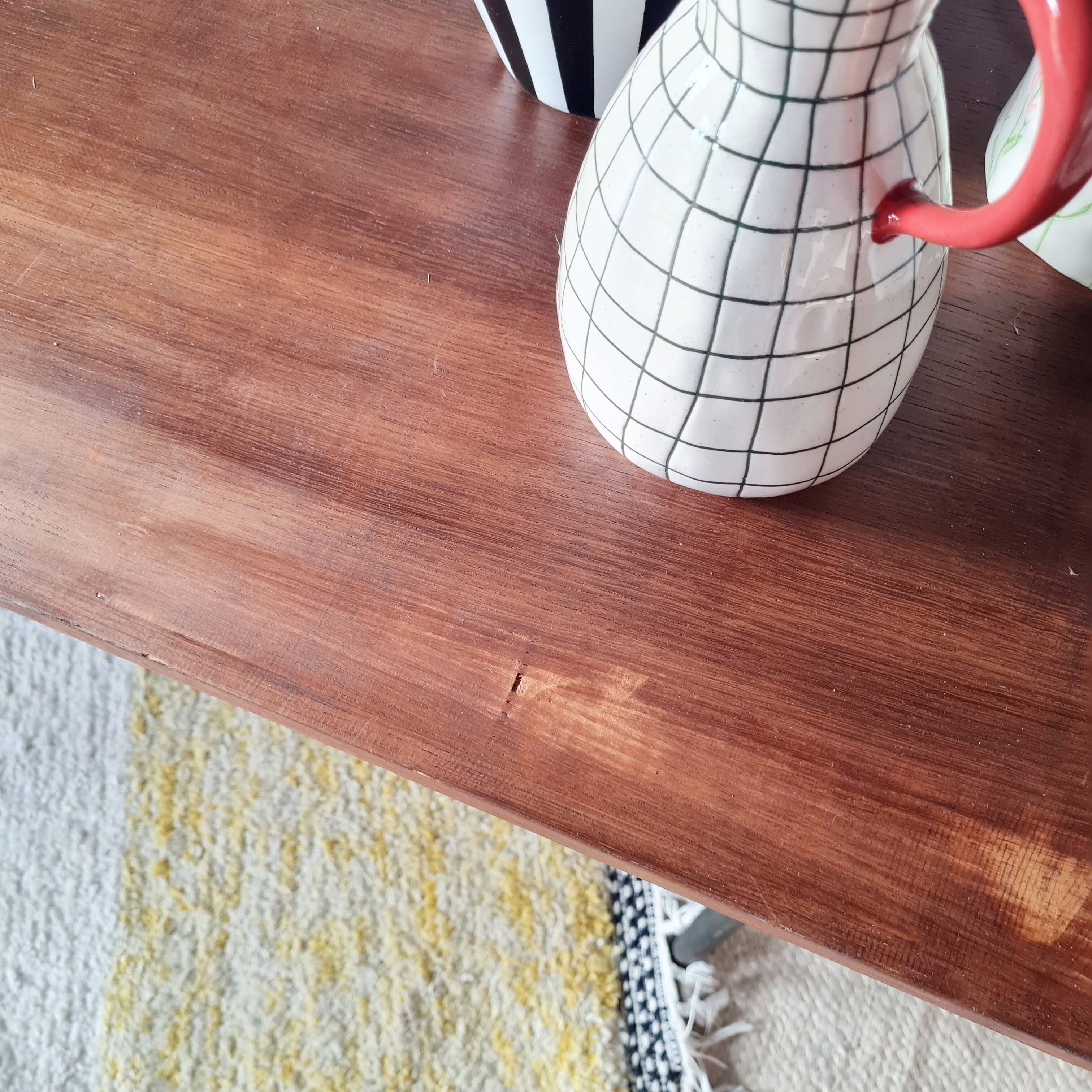 Table with tubular metal legs and wooden top.