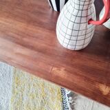 Table with tubular metal legs and wooden top.