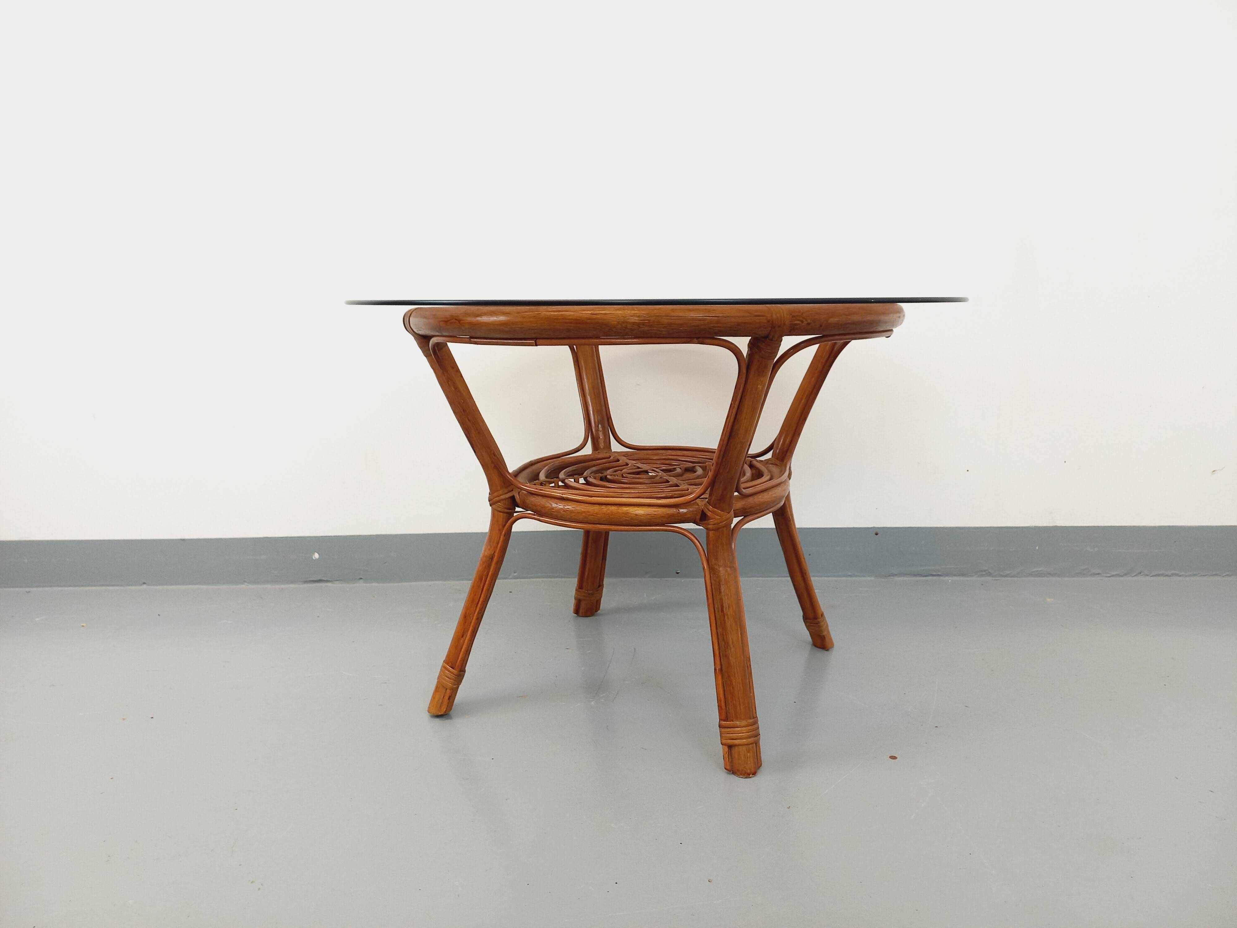 Vintage round smoked glass and rattan coffee table from the 70s