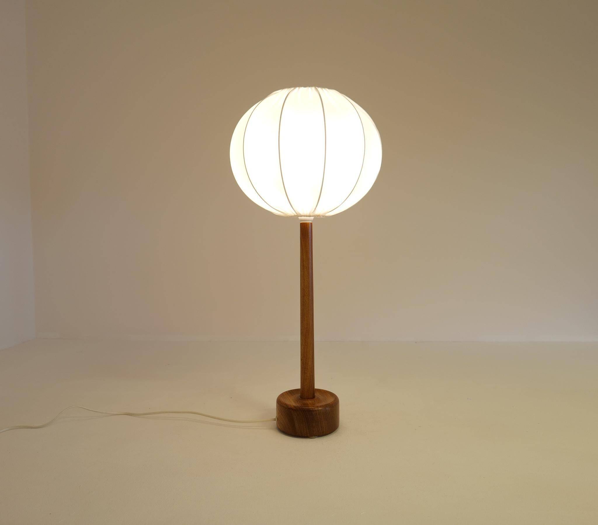 Mid-century solid teak table lamp from the 1960s Sweden.