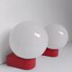 2 postmodern opaline and red metal wall lights, 1980