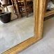 Gold sculpted and moulded stucco trumeau mirror 113 x 78 cm