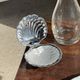 Vintage silver-plated shell butter dish with transparent bowl.