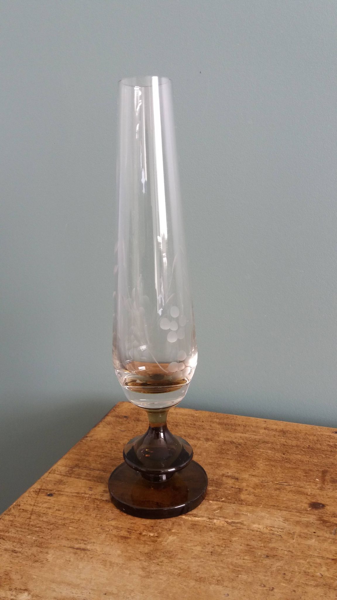 Cut glass soliflore vase with a smoked glass base.