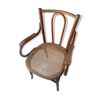 Old bistro armchair in caned wood