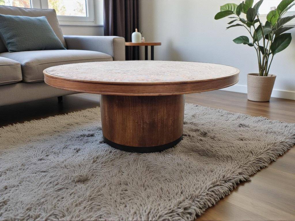 Vintage round wooden coffee table with a copper top.