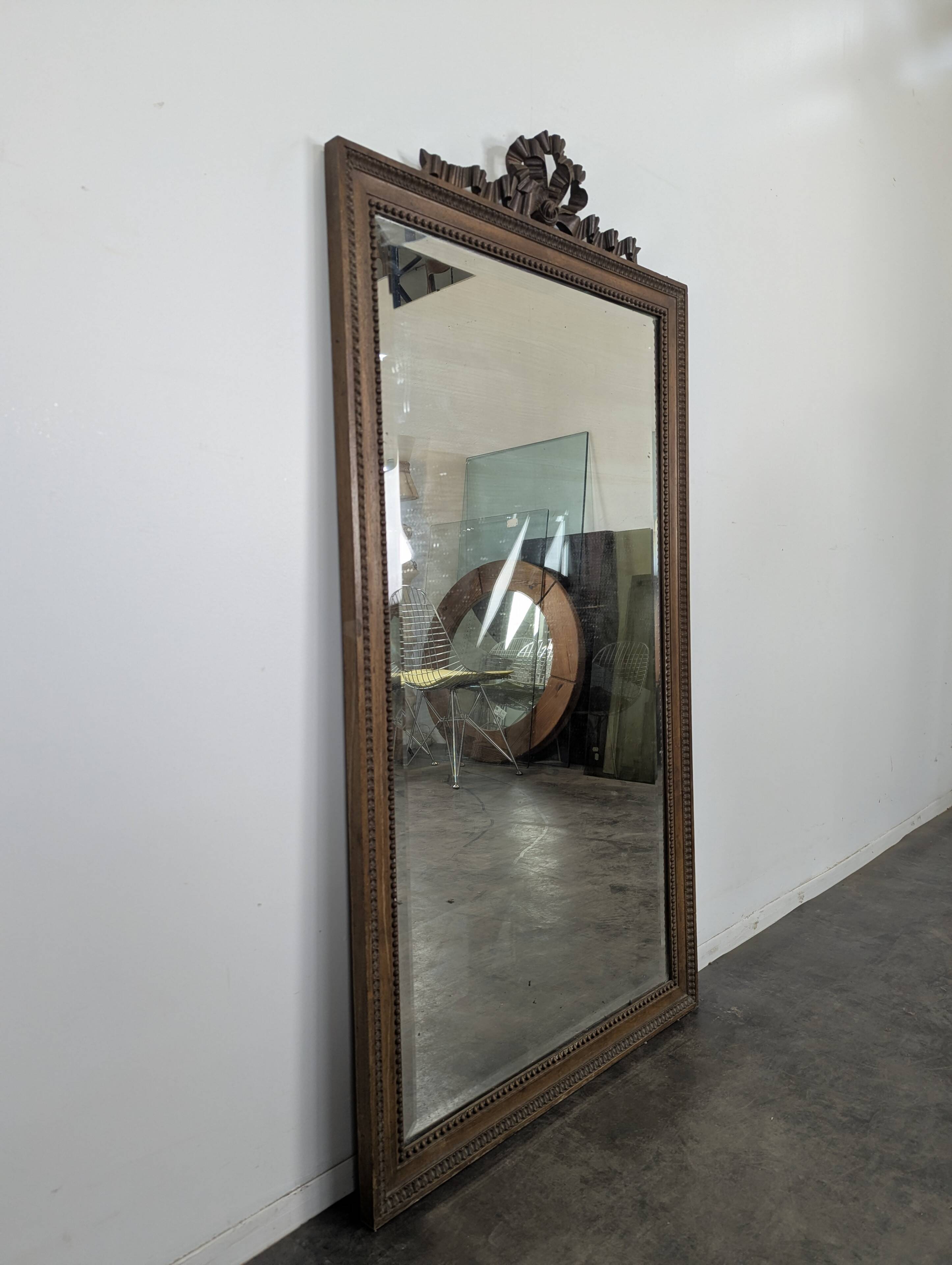 Louis XVI style mirror in carved walnut.