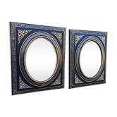 Pair of antique mirrors from the Napoléon III period, black and gilded.