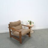 Brown-grey armchair with an oak frame.