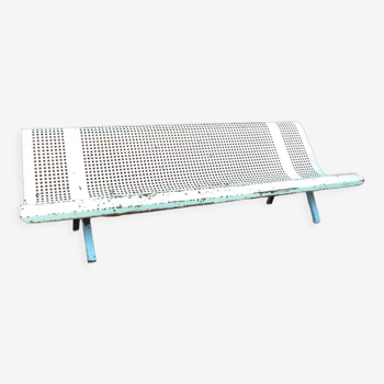 Perforated iron public bench
