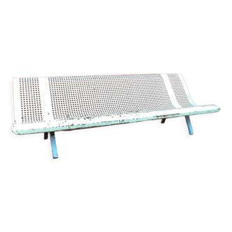 Perforated iron public bench