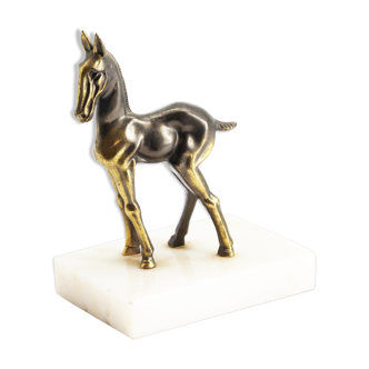 Brass donkey statue on marble