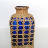 Blue bottle covered with wicker