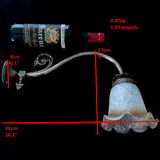 Brass wall lamp with speckled glass tulip