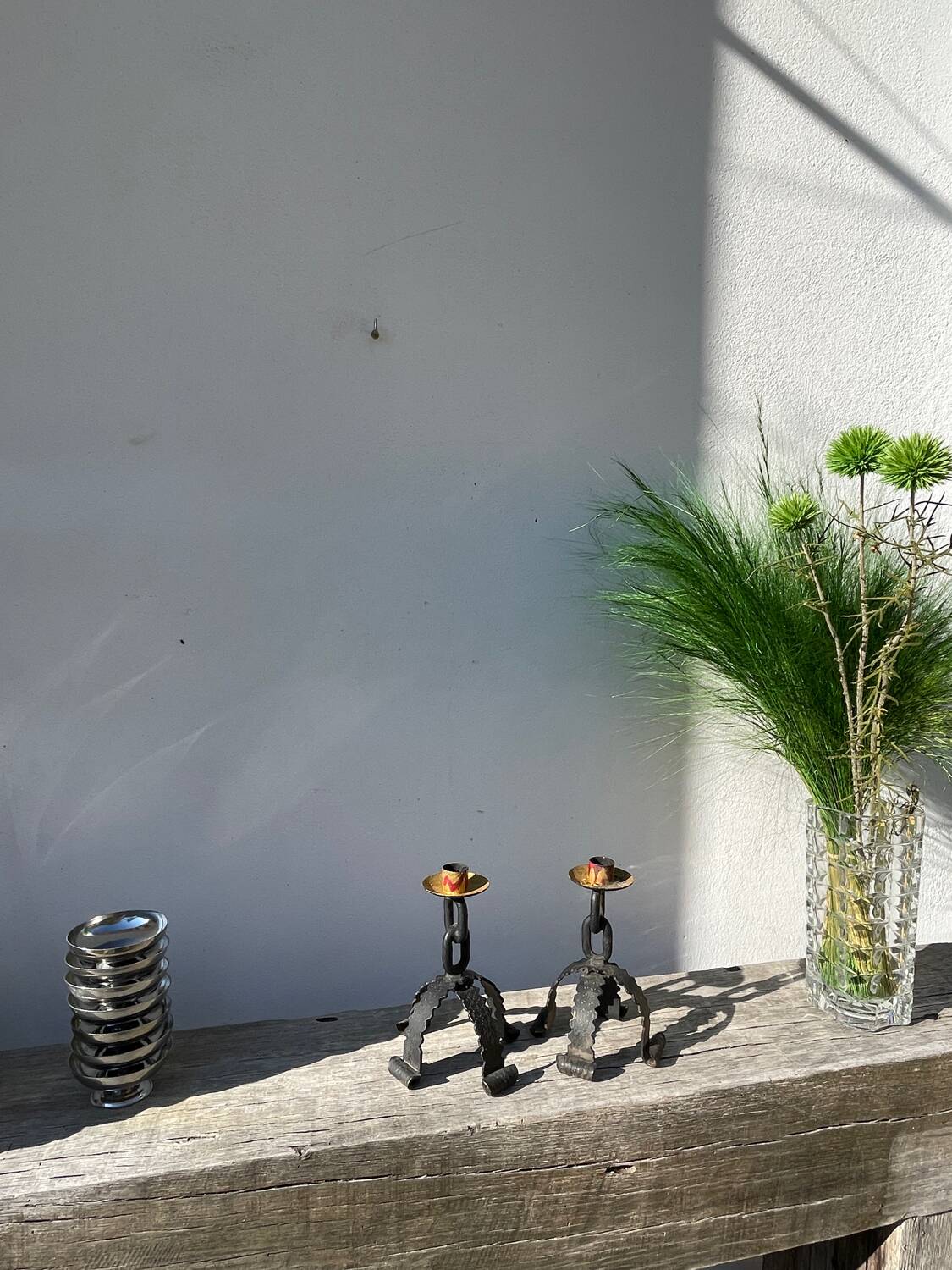 Pair of candlesticks with wrought iron chain