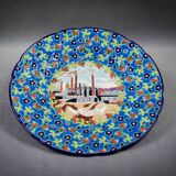 Longwy plate with polychrome enamels, decorated with the "City of Iron" motif.