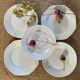 5 mismatched old white plates.