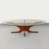 Vintage Hugues Poignant oval coffee table in teak and smoked glass from the 1970s