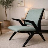Vintage armchair from the 1960s in black wood and fabric.
