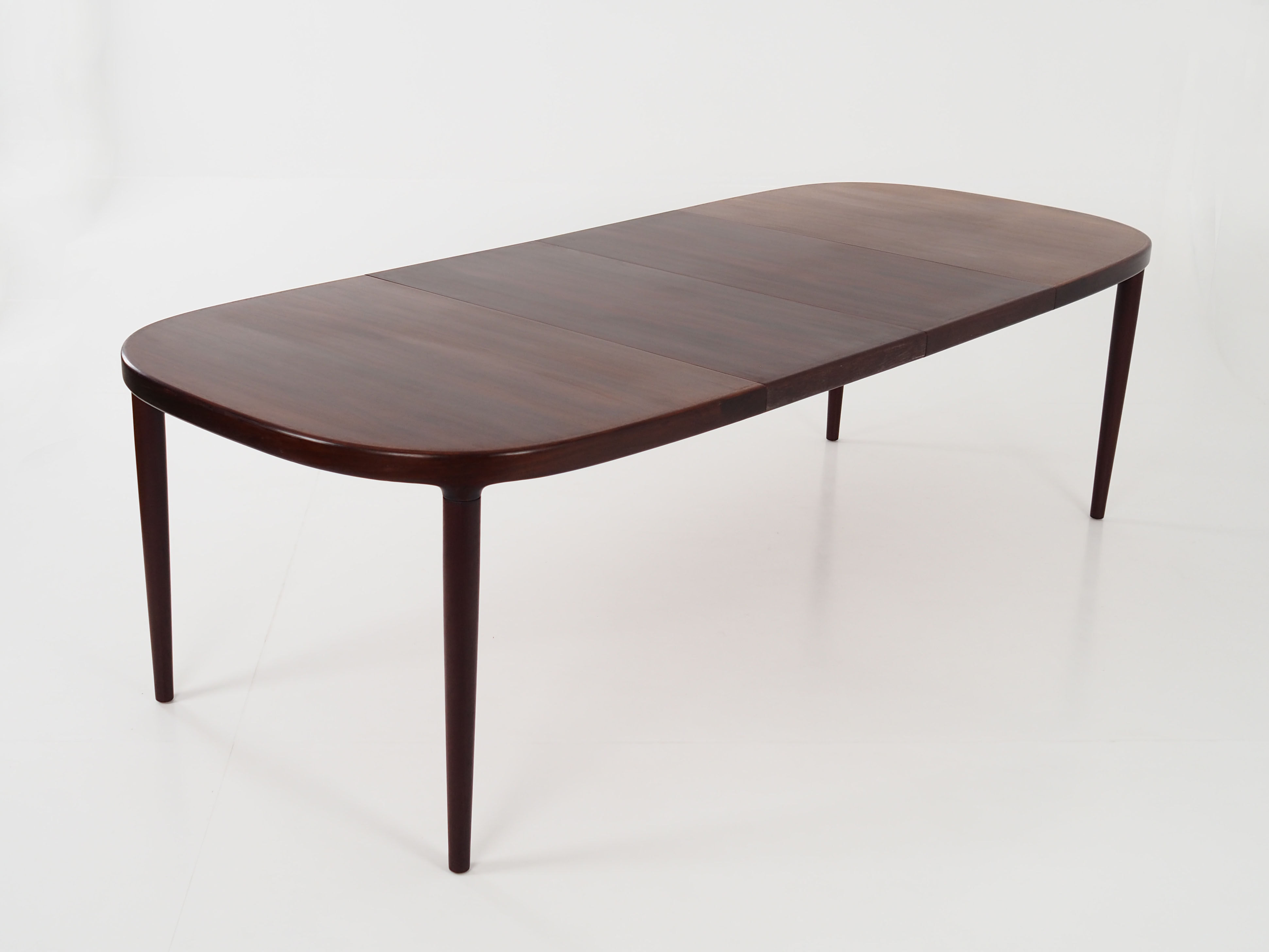 Oval table, covered with rosewood veneer.Design of the 70s