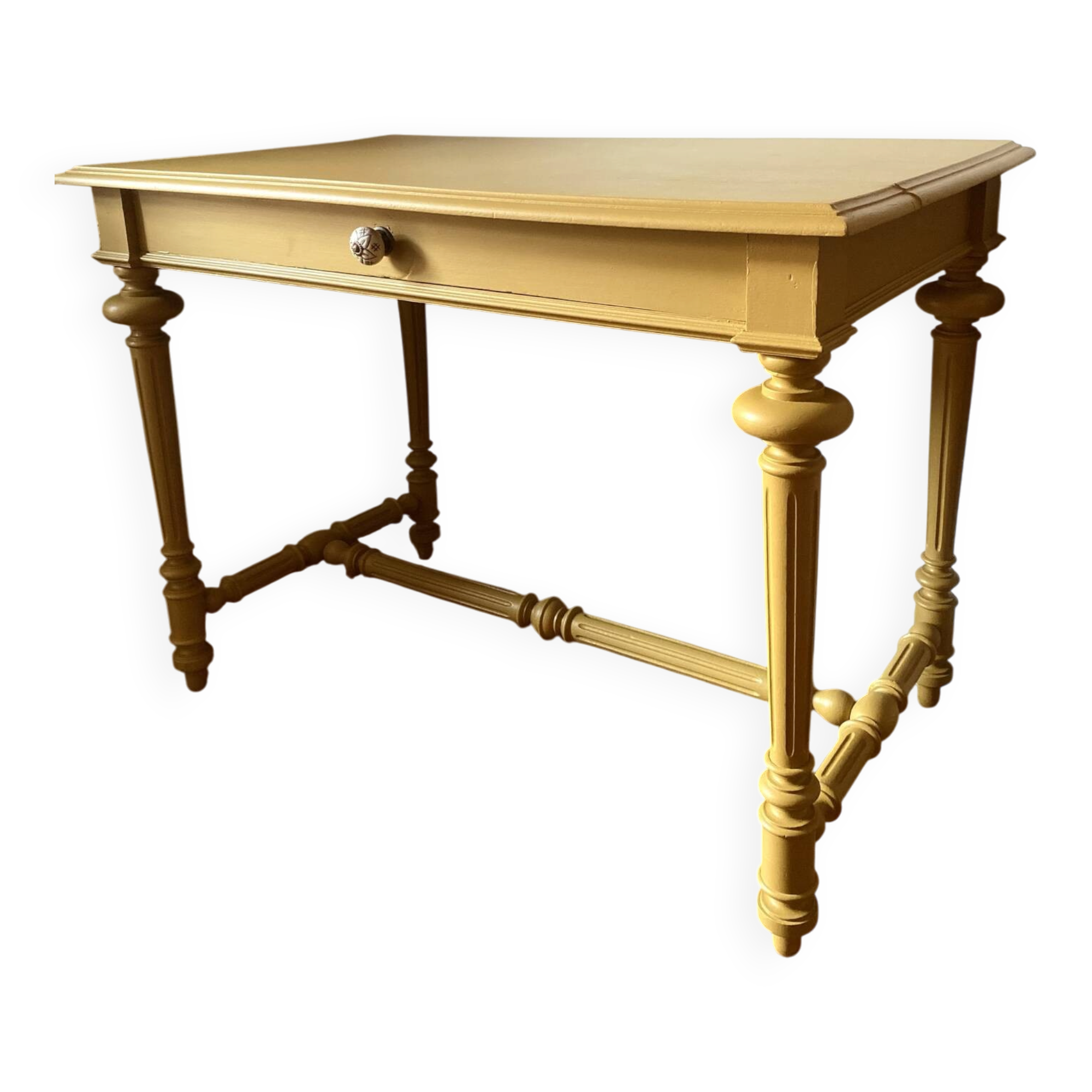 Desk table from the late 19th century, painted mustard, with turned stretcher.
