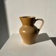 Small pitcher in light beige sandstone