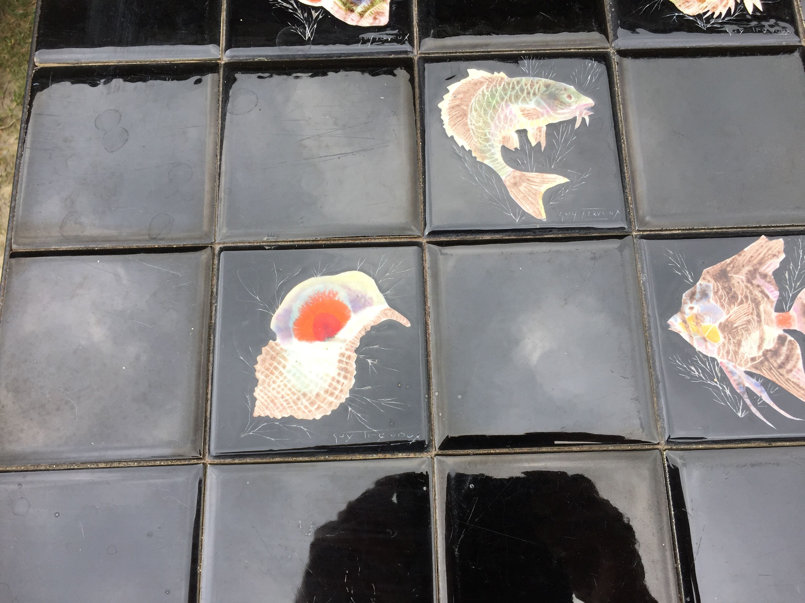 Vintage ceramic coffee table by Guy Trévoux with wrought iron base.