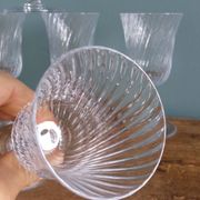 Ancient footed crystal glasses with relief twisted fluted goblets.